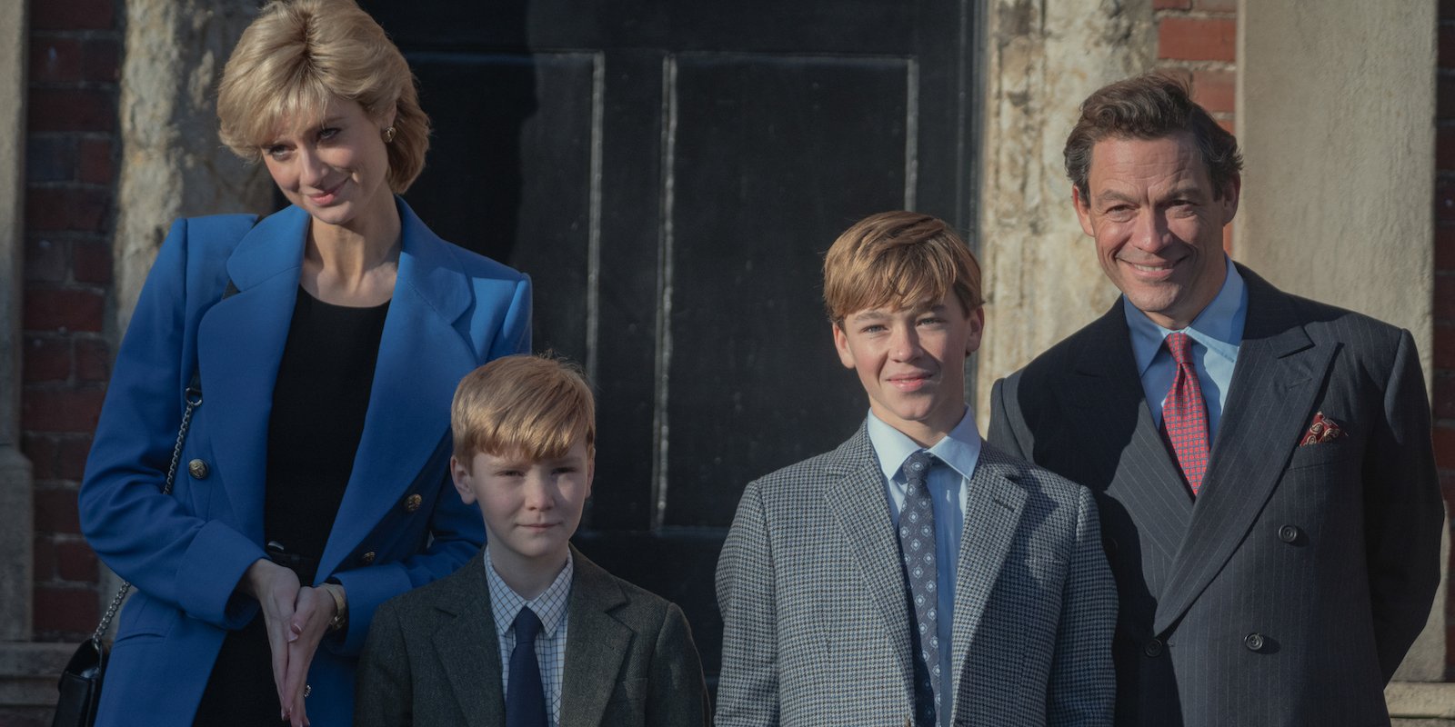 'The Crown': Season 5: Princess Diana (Elizabeth Debicki) and Prince Charles (Dominic West) stand behind Prince Harry (Will Powell) and William (Senan West)