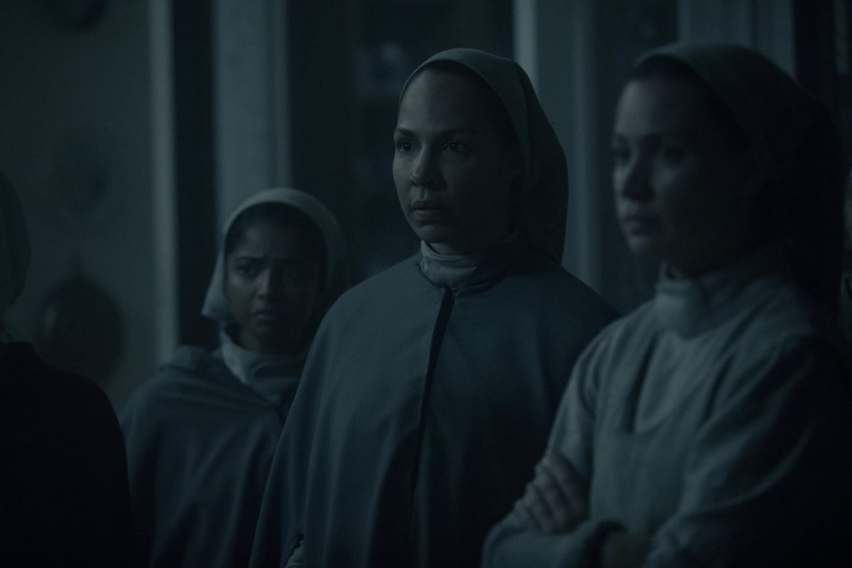 Marthas in The Handmaid's Tale wearing their gray dresses and hair covers.
