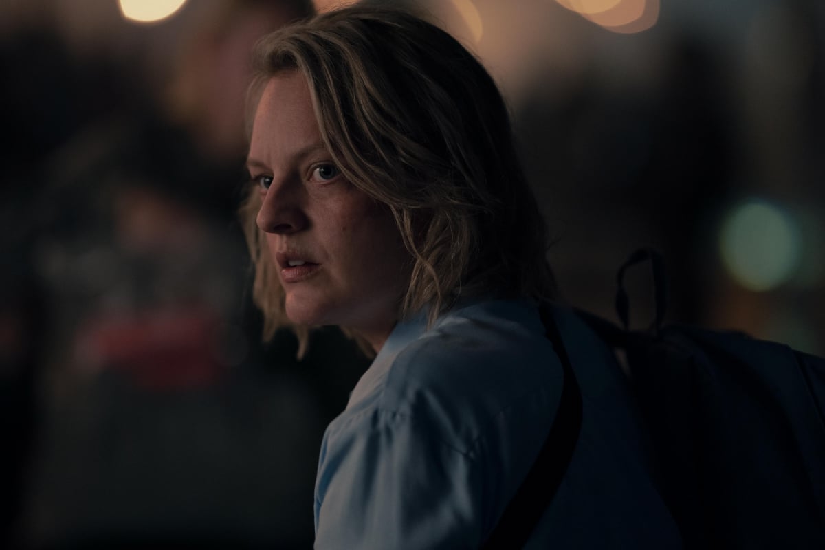 In The Handmaid's Tale Season 5, June wears a blue top and has short blonde hair.