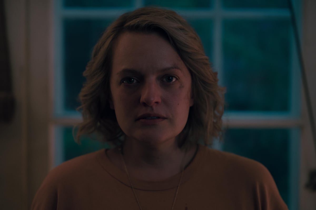 In The Handmaid's Tale Season 5 finale, June wears an orange top. She has short blonde hair and scratches on her face.