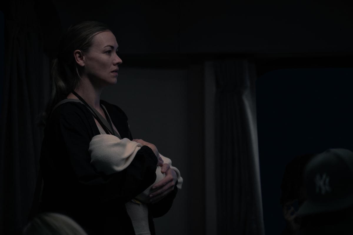 In The Handmaid's Tale Season 5 finale, Serena Joy stands in a train with baby Noah. 