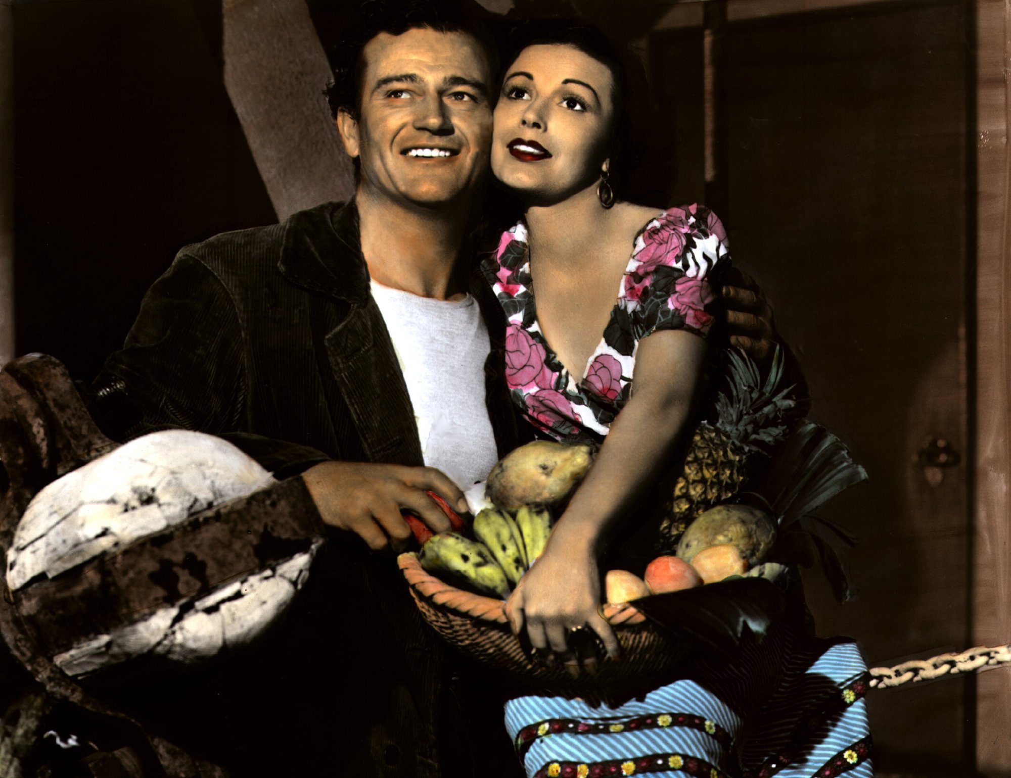 'The Long Voyage Home' John Wayne and Mildred Natwick. Natwick is holding a basket of fruit with her face against Wayne's face.