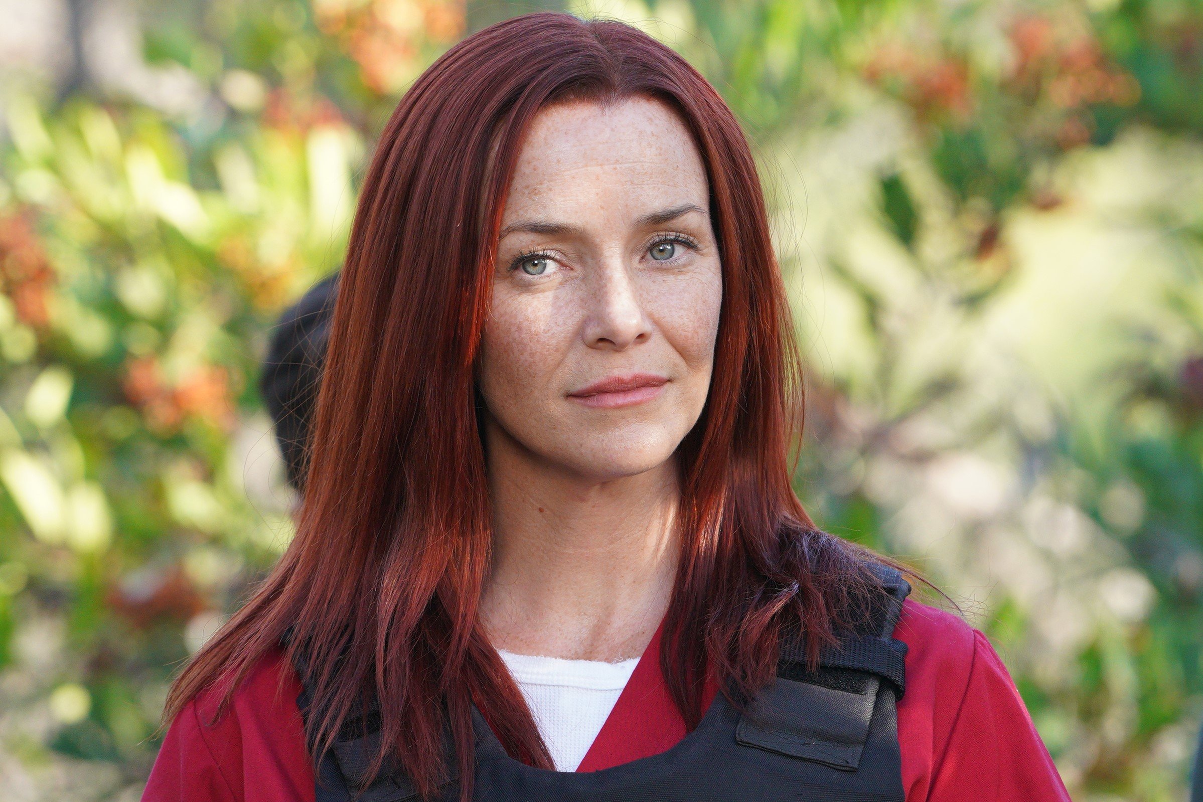 Annie Wersching, in character as Rosalind Dyer in 'The Rookie' Season 2, wears a red prison jumpsuit and black bulletproof vest.