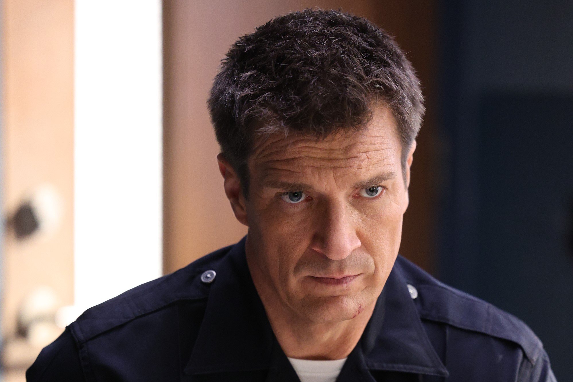 Nathan Fillion, in character as John Nolan in 'The Rookie' Season 5 Episode 9, which airs tonight, Dec. 4, on ABC, wears his blue police uniform.
