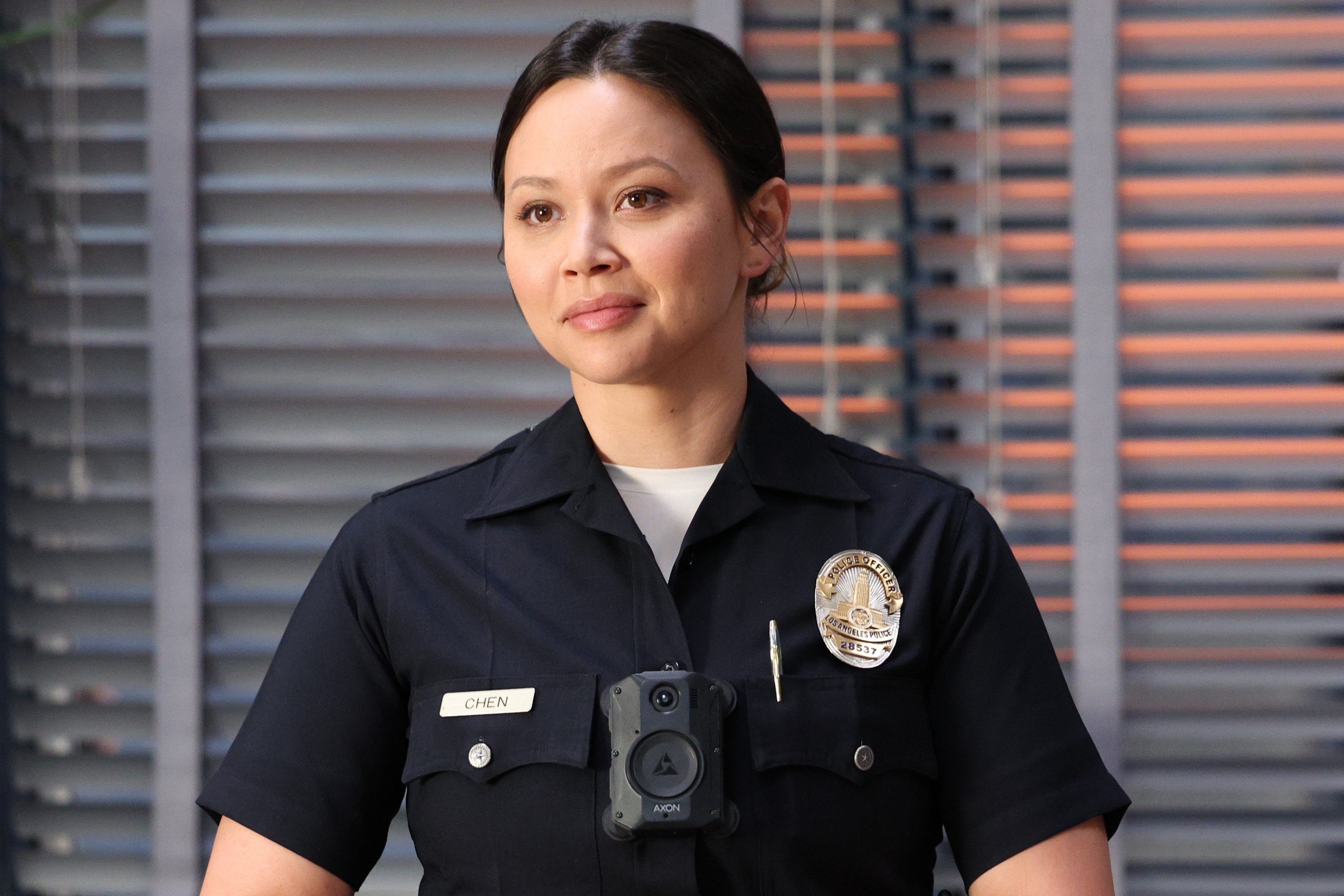 Melissa O'Neil stars as Lucy Chen in 'The Rookie' Season 5, which isn't on tonight, Nov. 13. Lucy wears her cop uniform in the photo.