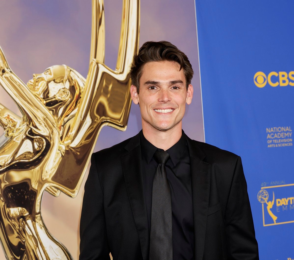 'The Young and the Restless' star Mark Grossman wearing a black suit and smiling during the 2022 Daytime Emmys.