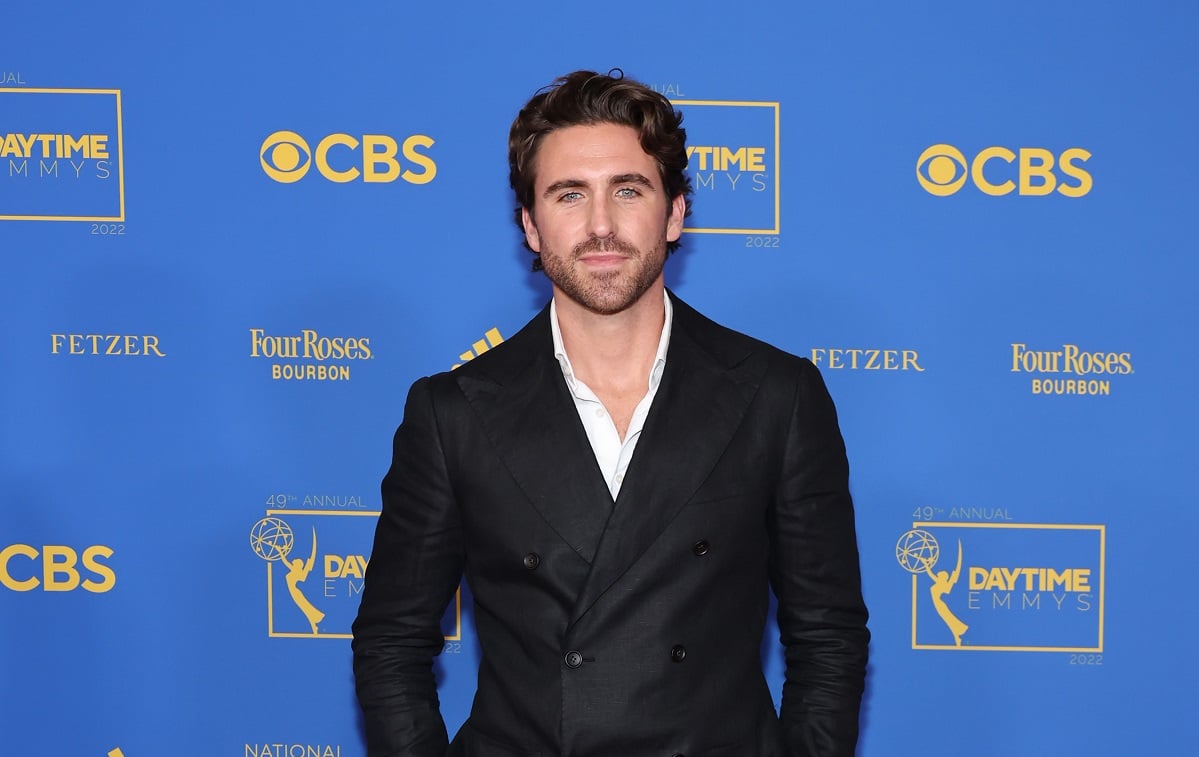 'The Young and the Restless' star Conner Floyd in a black suit, poses for a photo on the red carpet.