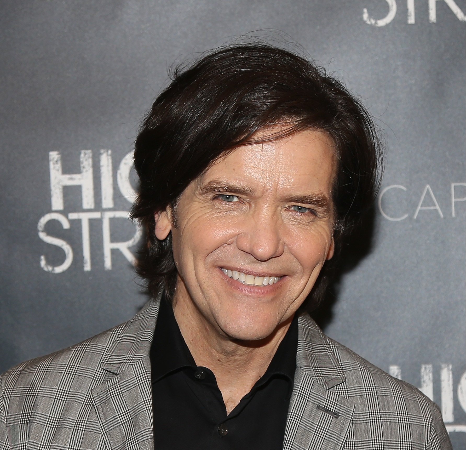 'The Young and the Restless' star Michael Damian wearing a grey suit and black shirt.