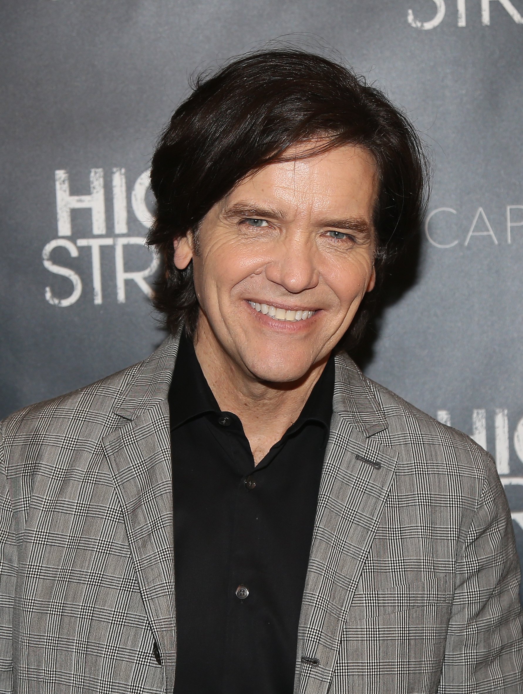 'The Young and the Restless' star Michael Damian wearing a grey suit and black shirt.