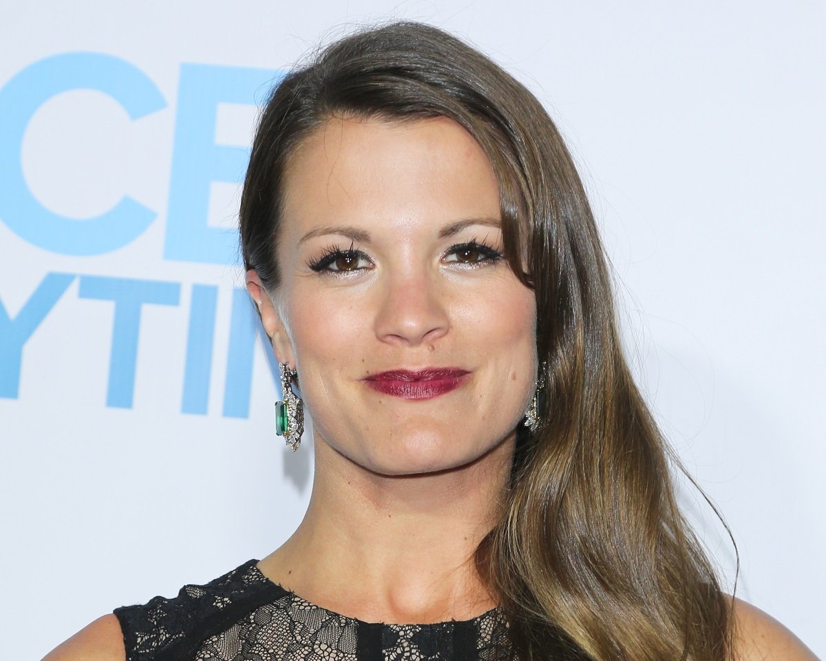 'The Young and the Restless' star Melissa Claire Egan in a black dress, poses on the red carpet.