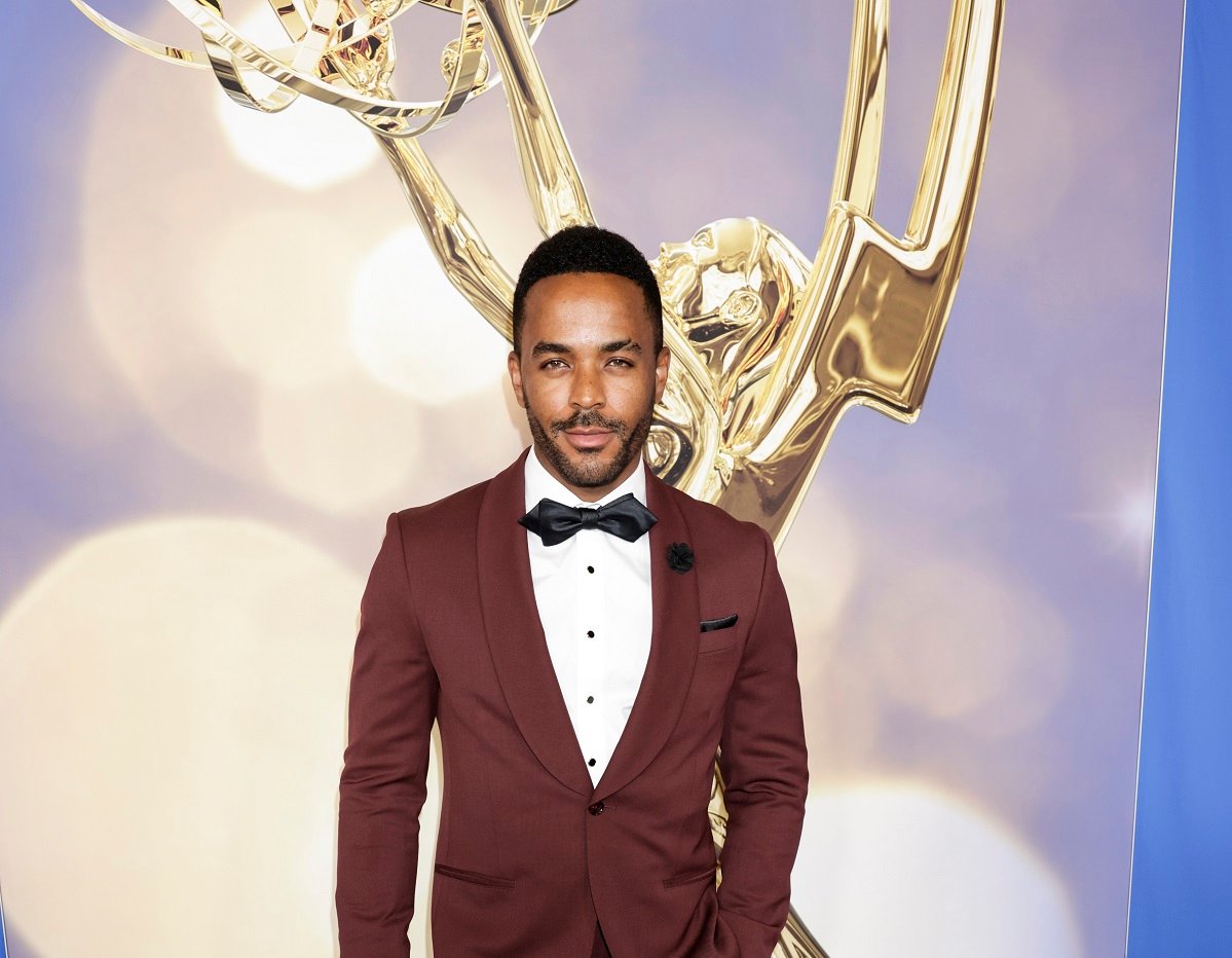 'The Young and the Restless' star Sean Dominic wearing a burgundy suit and posing on the red carpet of the 2022 Daytime Emmys.