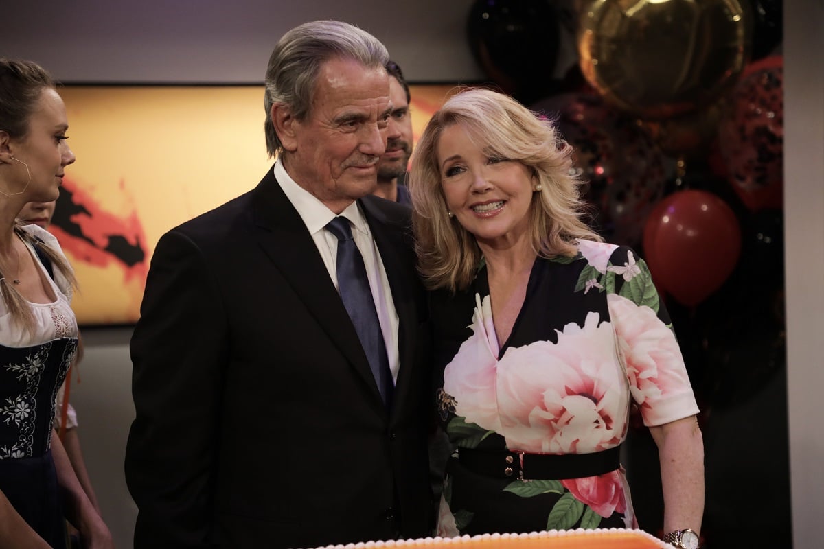 'The Young and the Restless' star Eric Braeden in a black suit and Melody Thomas Scott in a floral dress, pose together during his 40th anniversary celebration.