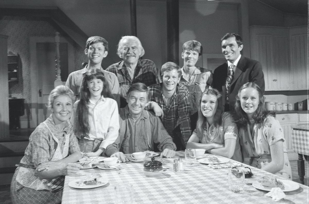 Black and white photo of 'The Waltons' cast sitting at the table