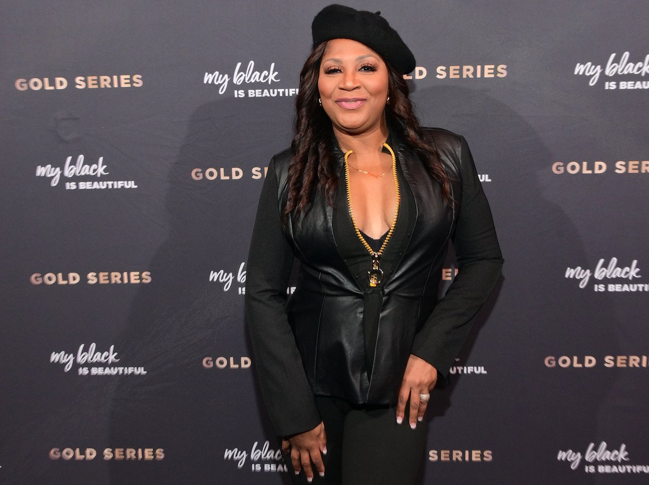Trina Braxton smiles and poses on the red carpet; Braxton recently filed a police report