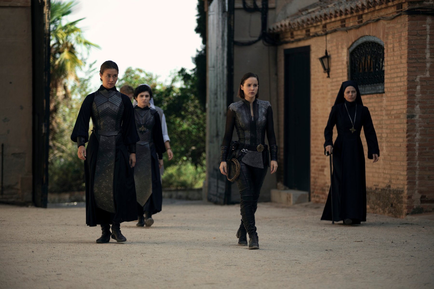 Kristina Tonteri-Young as Sister Beatrice, Olivia Delcán as Sister Camila, Alba Baptista as Ava Silva, Sylvia De Fanti as Mother Superion in 'Warrior Nun' for our article about season 3. They're all dressed in black and walking near one another.