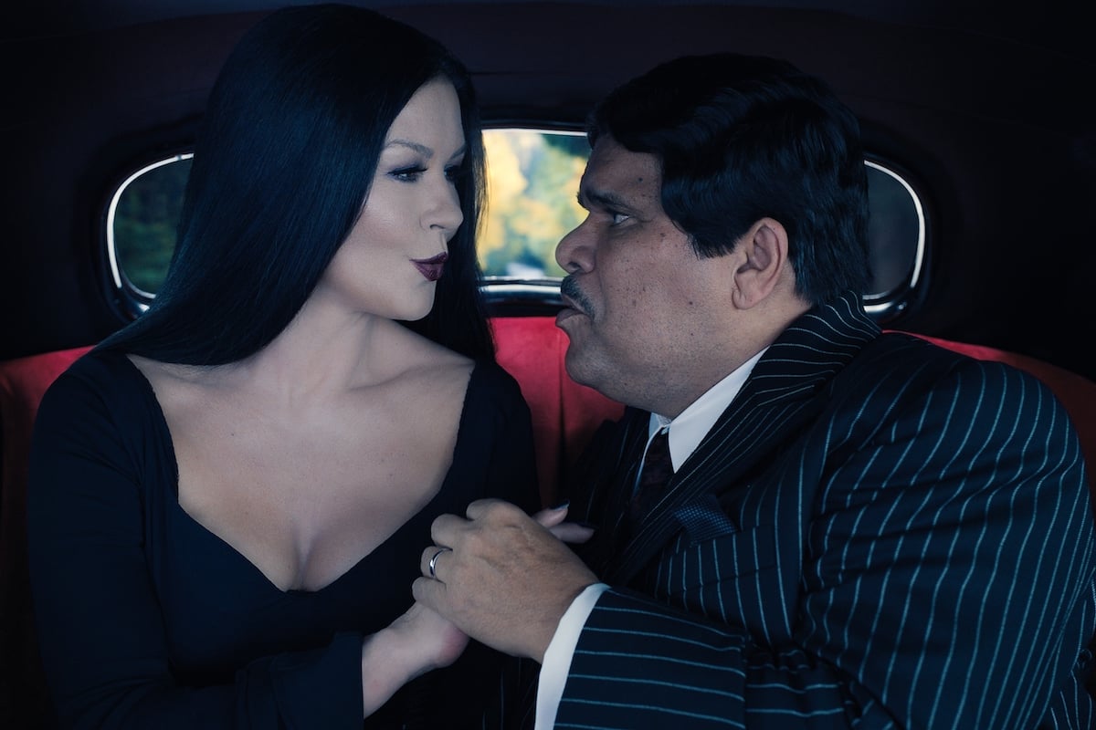 'Wednesday': Addams Family parents Morticia (Catherine Zeta-Jones) and Gomez (Luis Guzman) cuddle in the back of their car