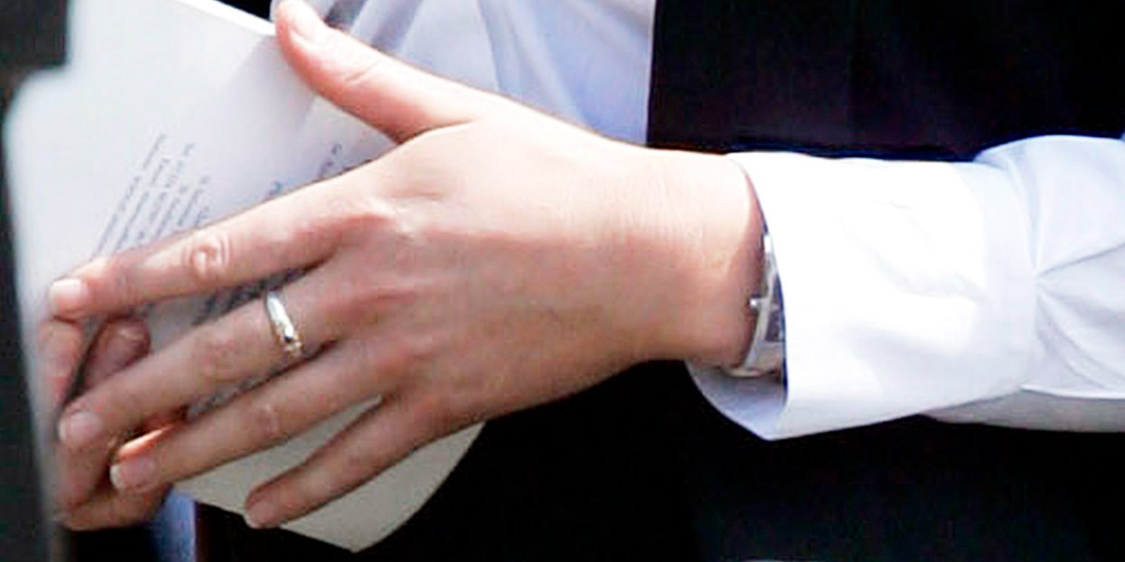 A close up photograph of Kate Middleton's hands at her college graduation, wearing the ring Prince William gifted her containing garnets and pearls.