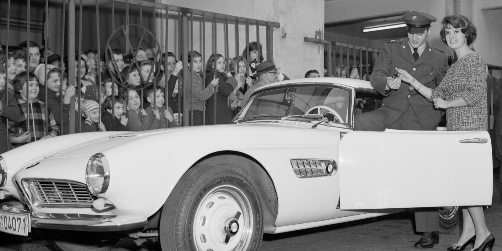 Elvis Presley poses with his white BMW in Germany.