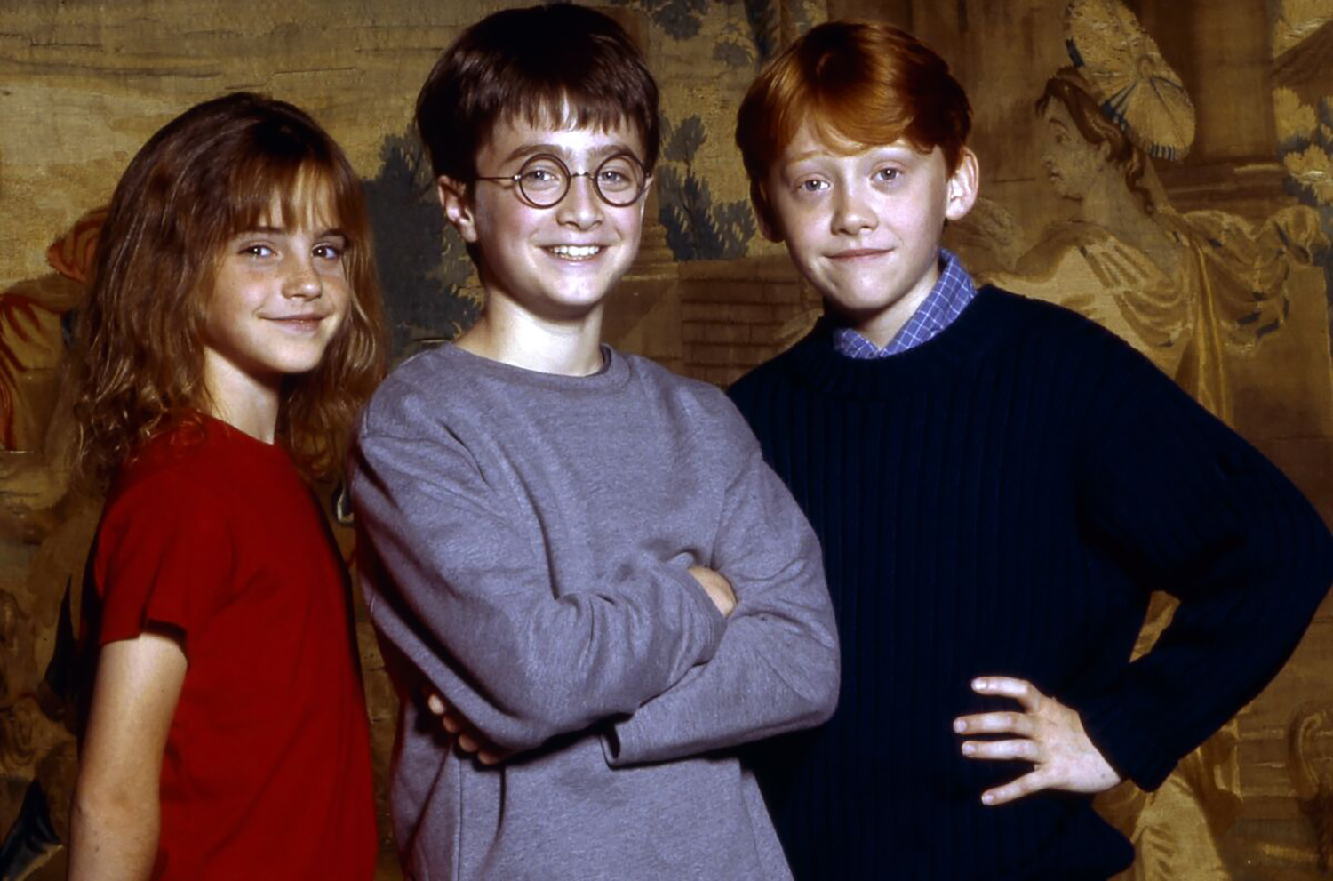 Young Harry Potter movie stars Emma Watson, Daniel Radcliffe, and Rupert Grint smile and pose together
