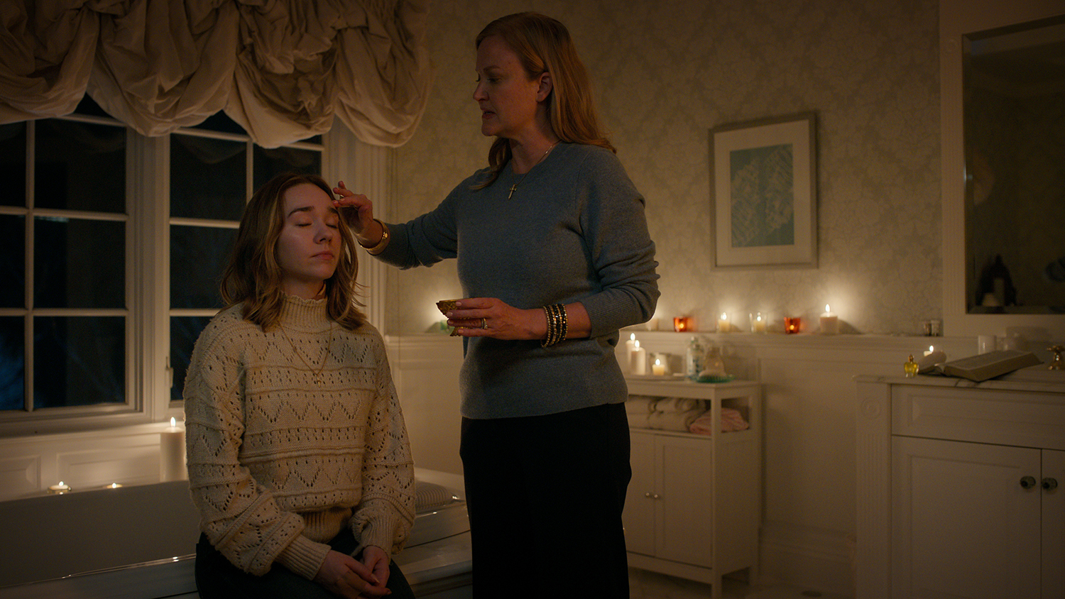 Holly Taylor as Angelina Meyer and Heidi Armbruster as Noelle Meyer blessing Angelina's forehead in Manifest Season 4 Episode 6.