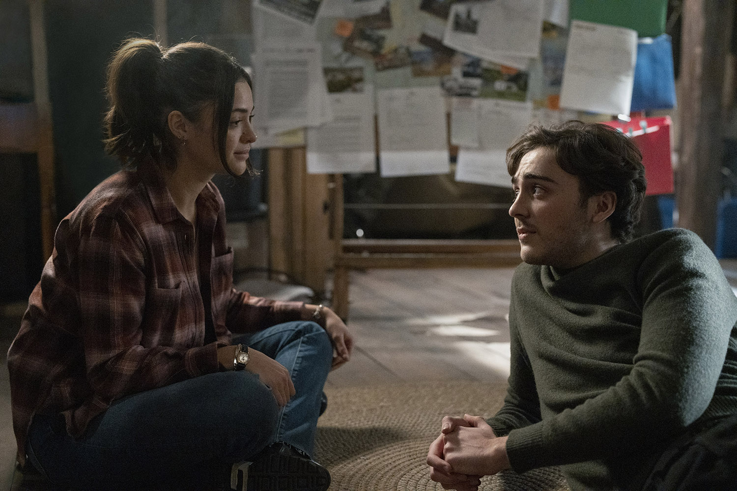 Luna Blaise as Olive Stone and Ty Doran as Cal Stone sitting on the floor and talking to each other in Manifest Season 4 Part 1.