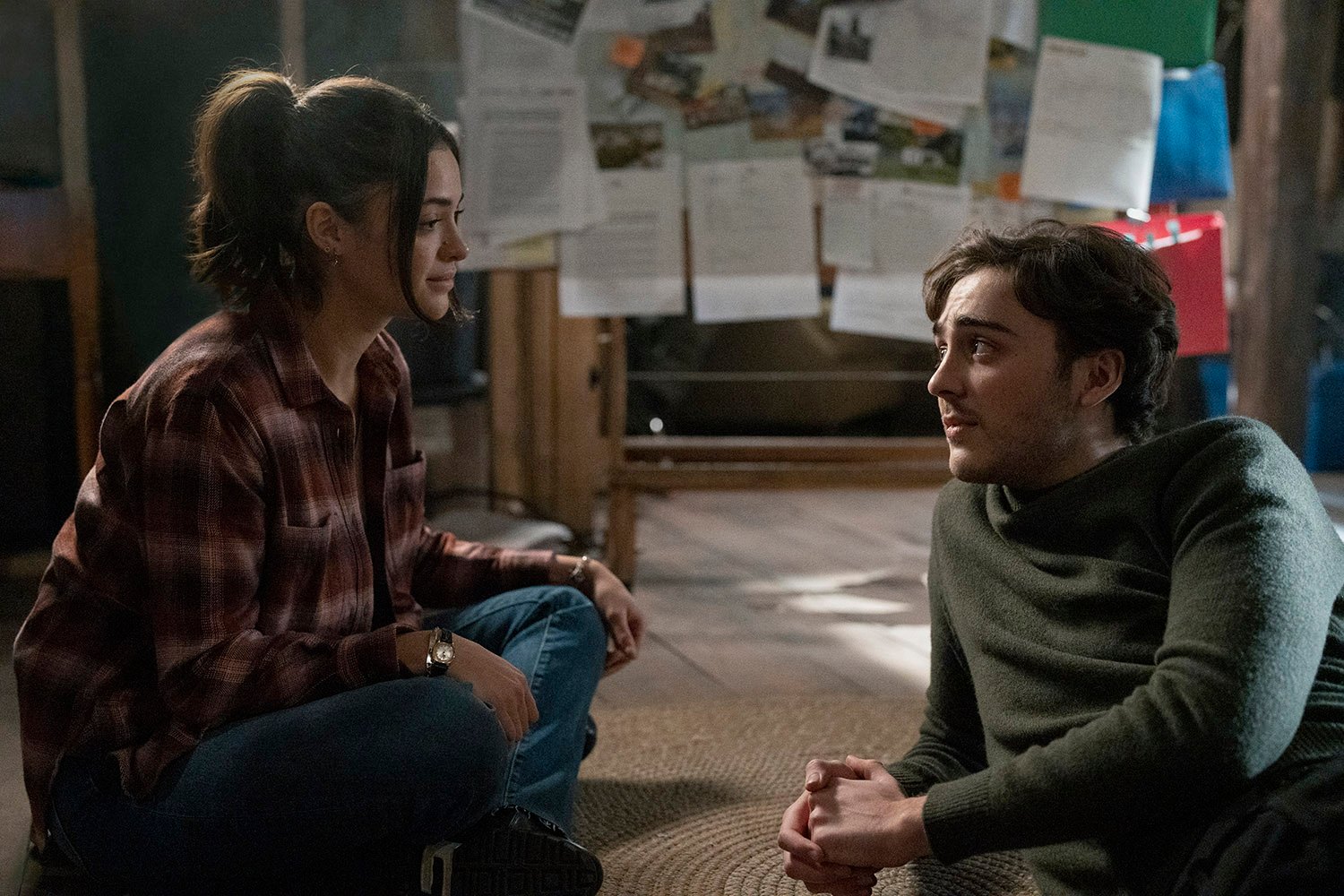 Luna Blaise as Olive Stone and Ty Doran as Cal Stone sitting on the floor and talking to each other in Manifest Season 4 Part 1.