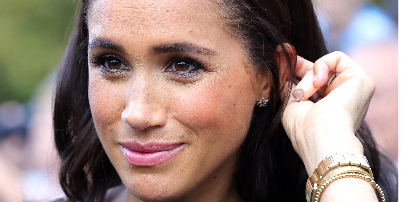 Meghan Markle touches her hair during a walkabout ahead of the funeral of Queen Elizabeth II in September 2022.