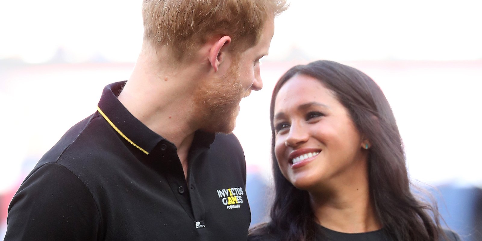 Prince Harry and Meghan Markle look at one another during an Invictus Games event.