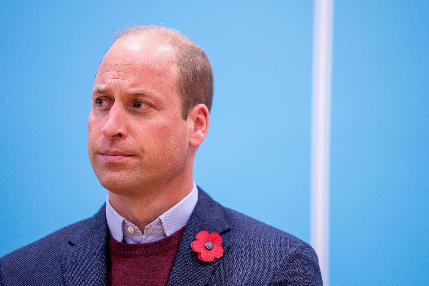 Prince William body language and expression appears serious