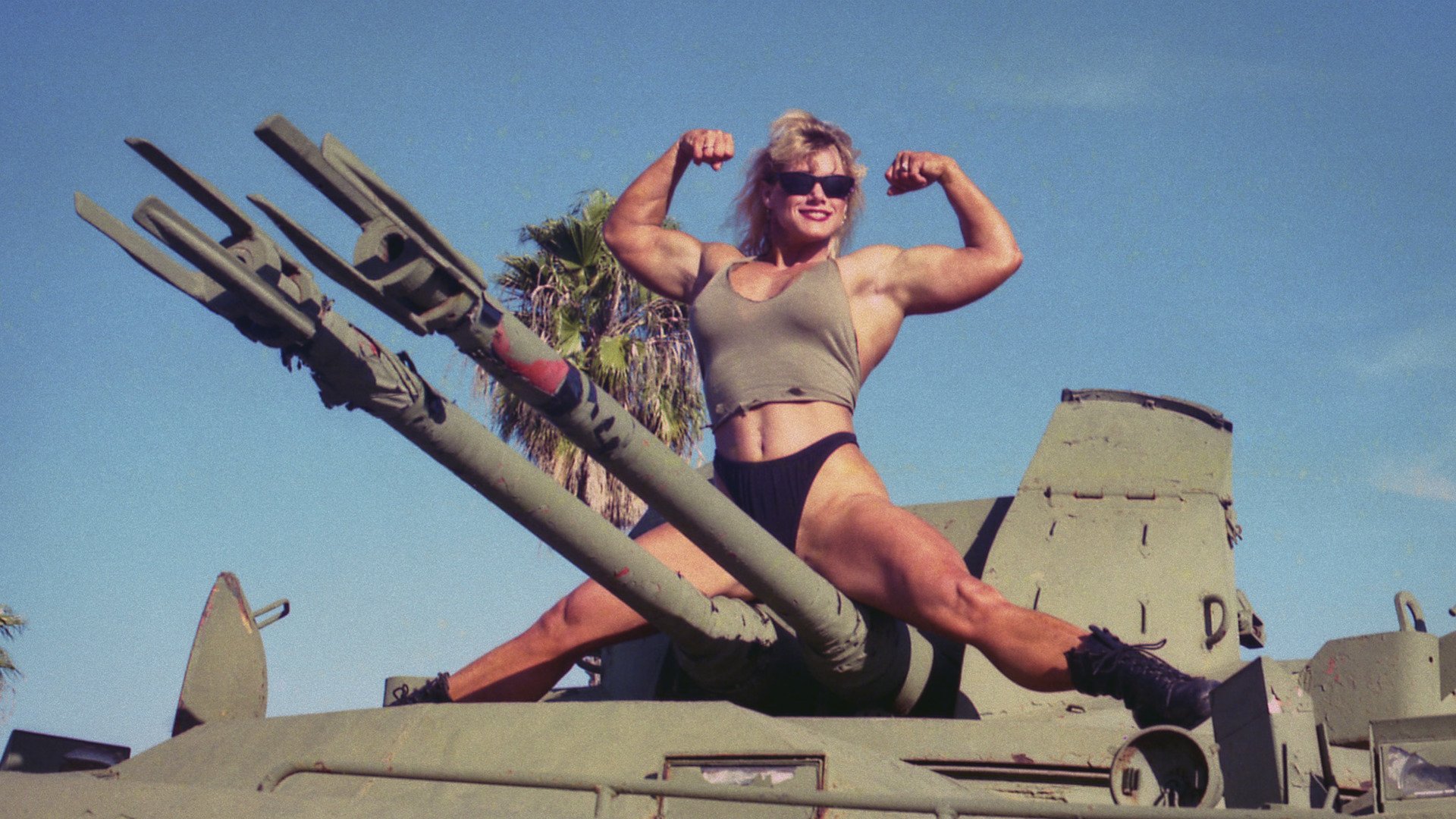 Sally McNeil flexes for a photo from her time in the military