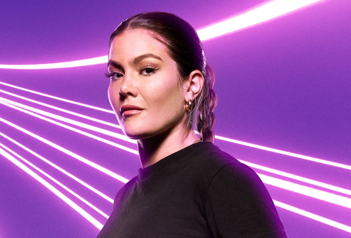 'The Challenge' Season 38 star Tori Deal wearing black against a purple background