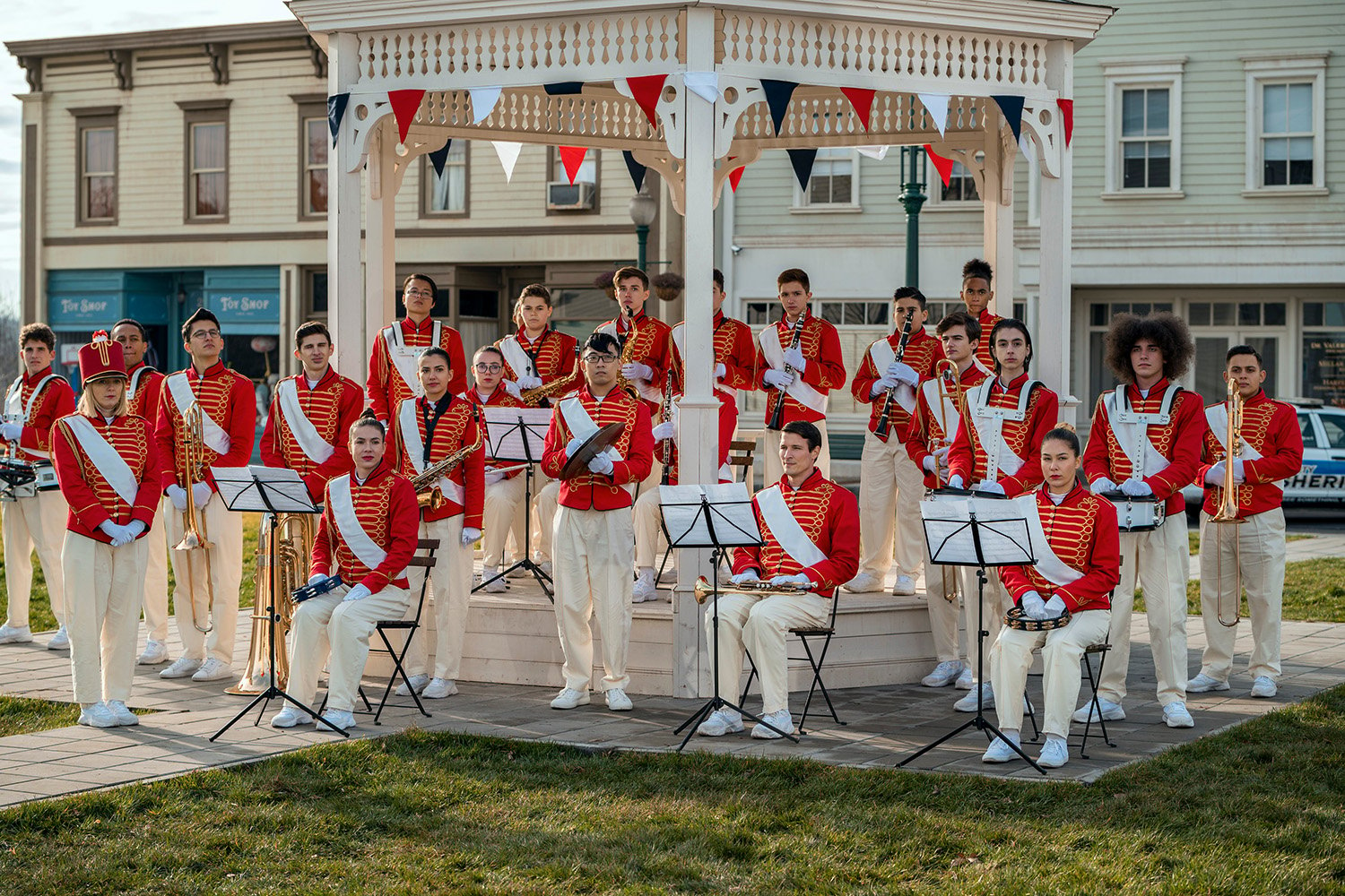 A marching band in red uniforms performs in the town square in Wednesday, which many Gilmore Girls fans think looks like Stars Hollow.