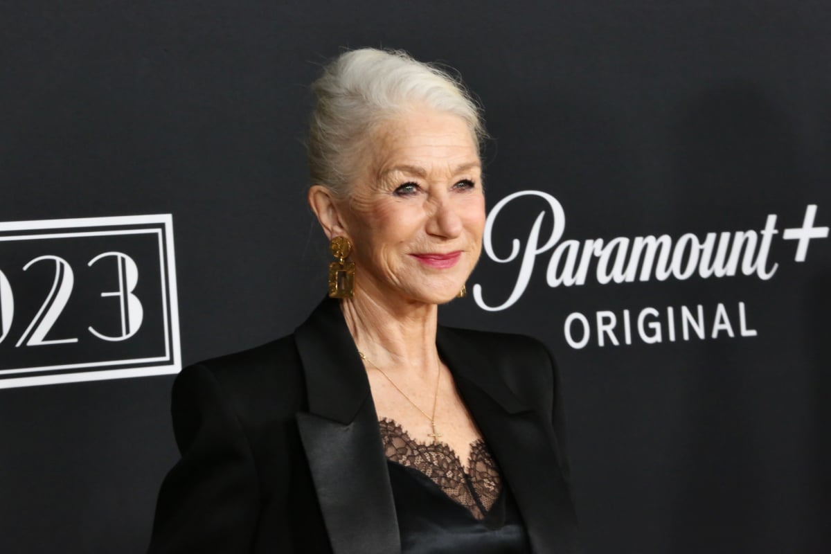 1923 star Helen Mirren attends the series premiere wearing a black blazer and black dress with lace trim underneath.