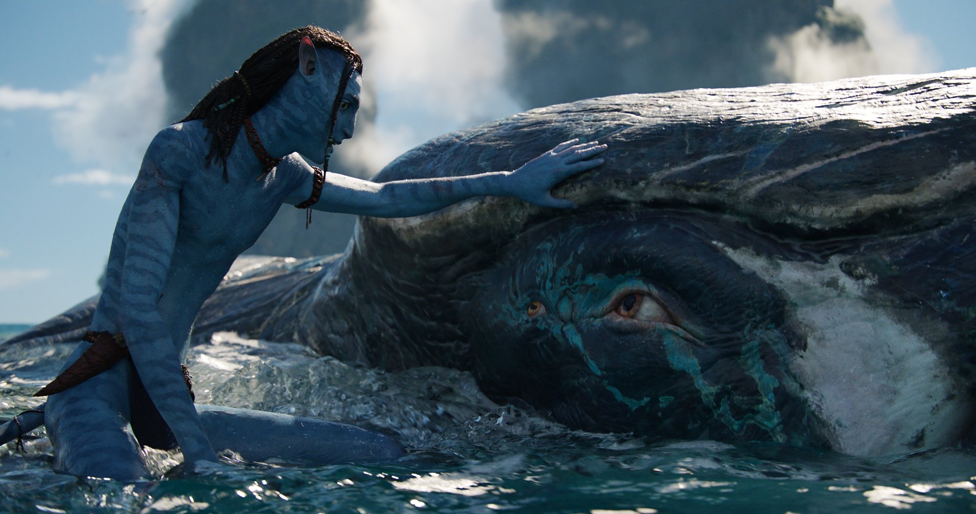 'Avatar: The Way of Water' Lo'ak (Britain Dalton) petting a Tulkun while sitting in the ocean