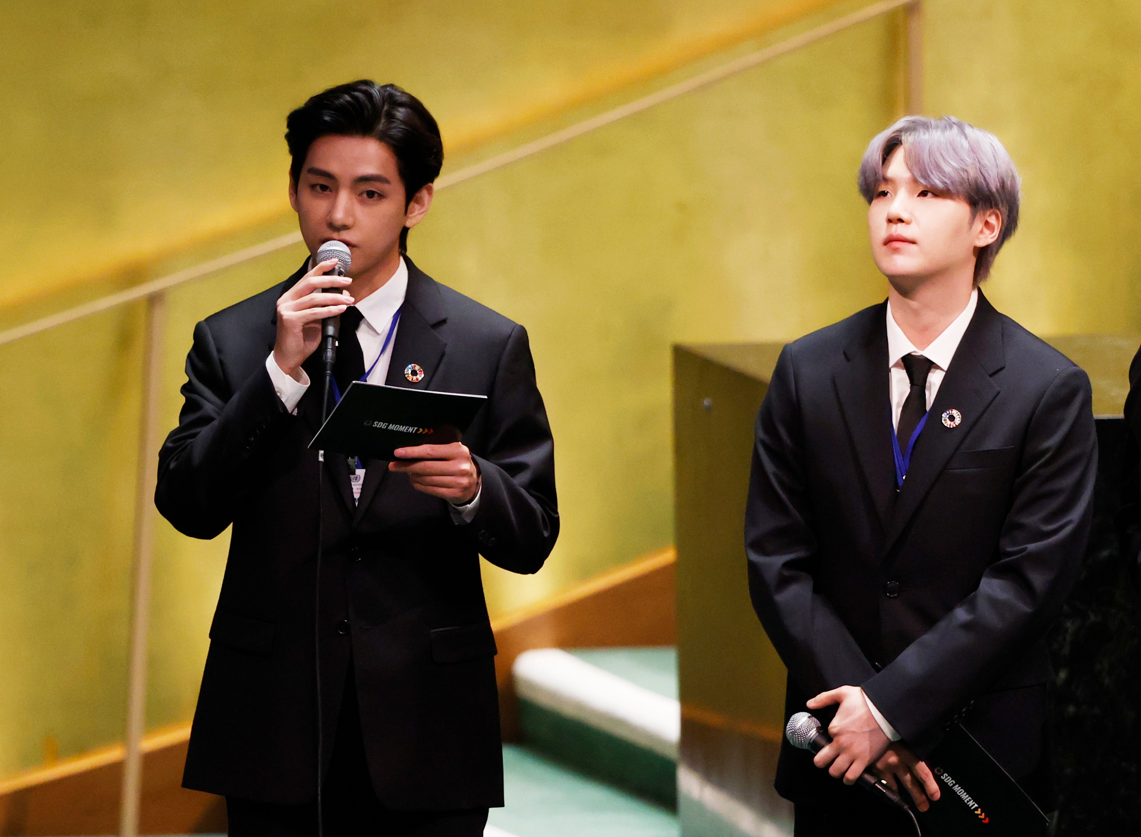 Suga listens as Taehyung/V of boy band BTS speaks at the SDG Moment event