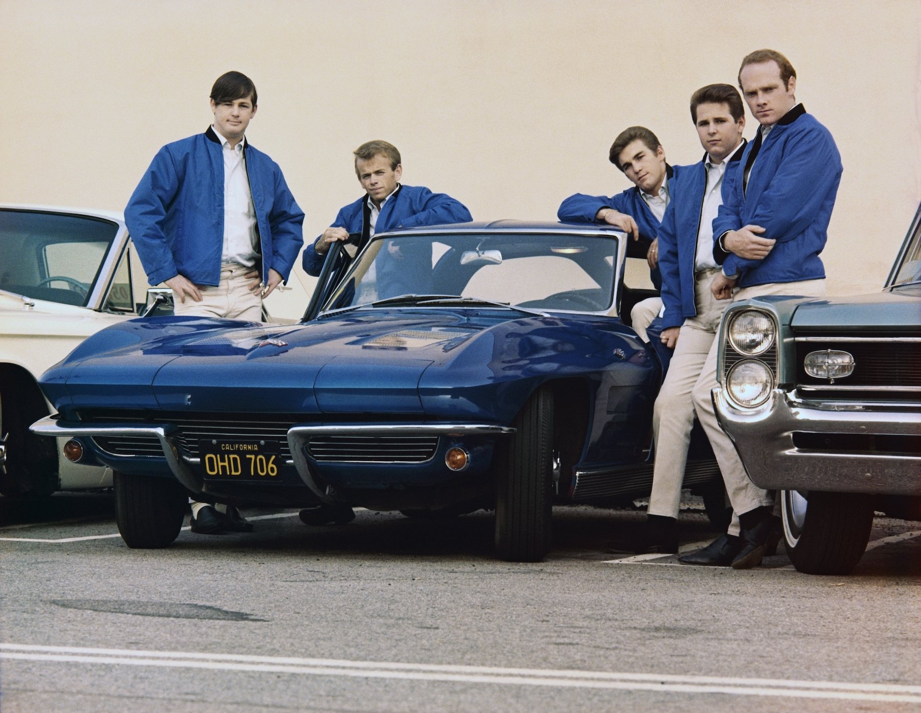 Rock and roll group The Beach Boys pose with Corvette (Brian Wilson, Al Jardine, Dennis Wilson, Carl Wilson, Mike Love)