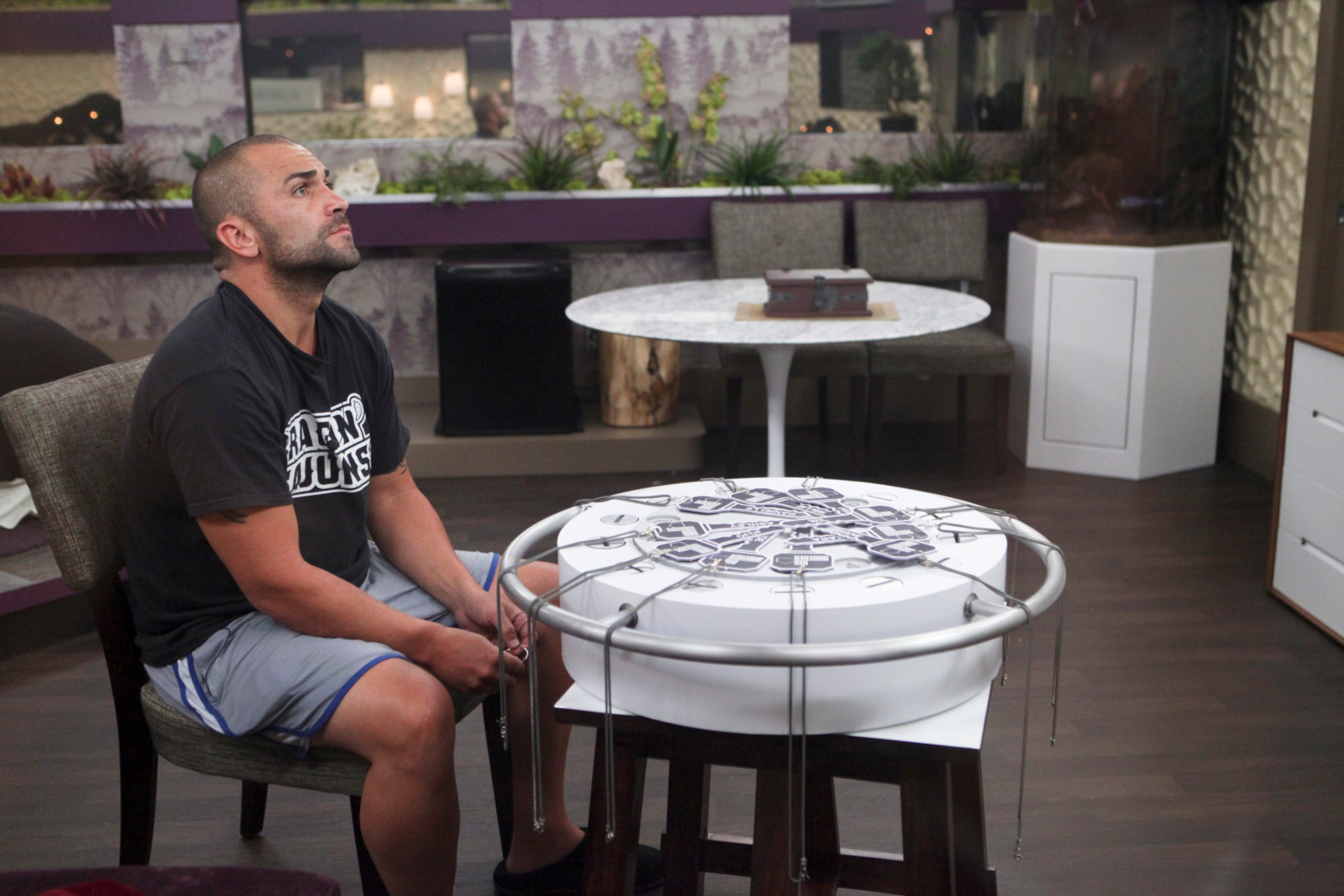 'Big Brother' Season 14 contestant Willie Hantz. He's sitting at a table and thinking.