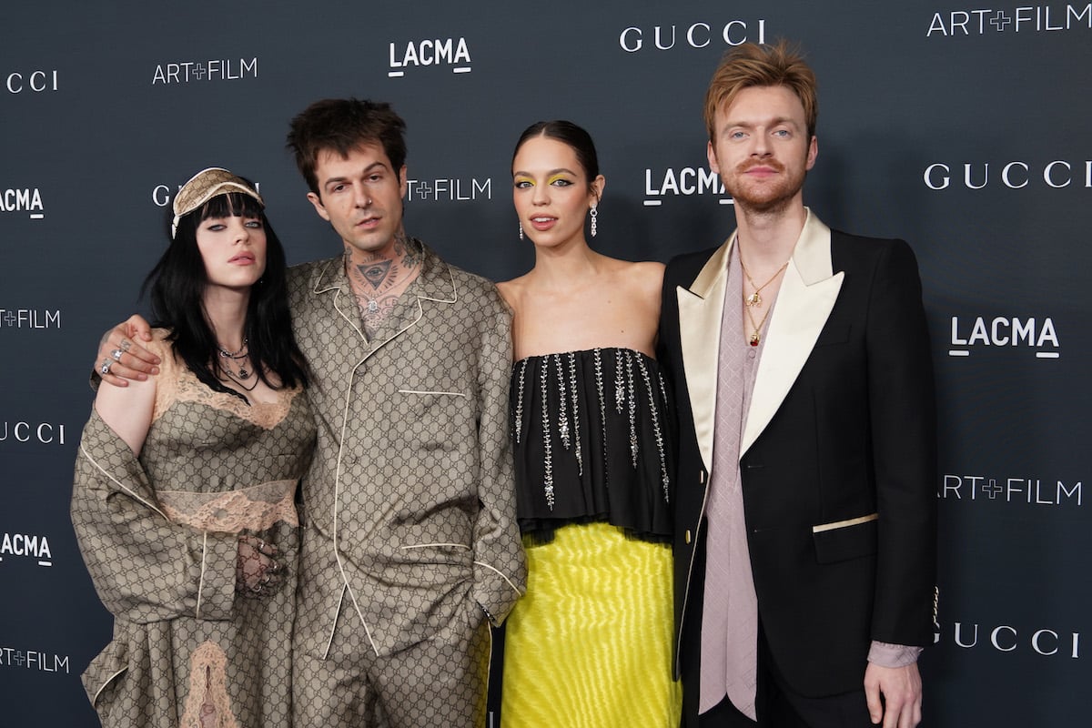 Billie Eilish, Jesse Rutherford, Claudia Sulewski, and Finneas O'Connell pose together at an event.
