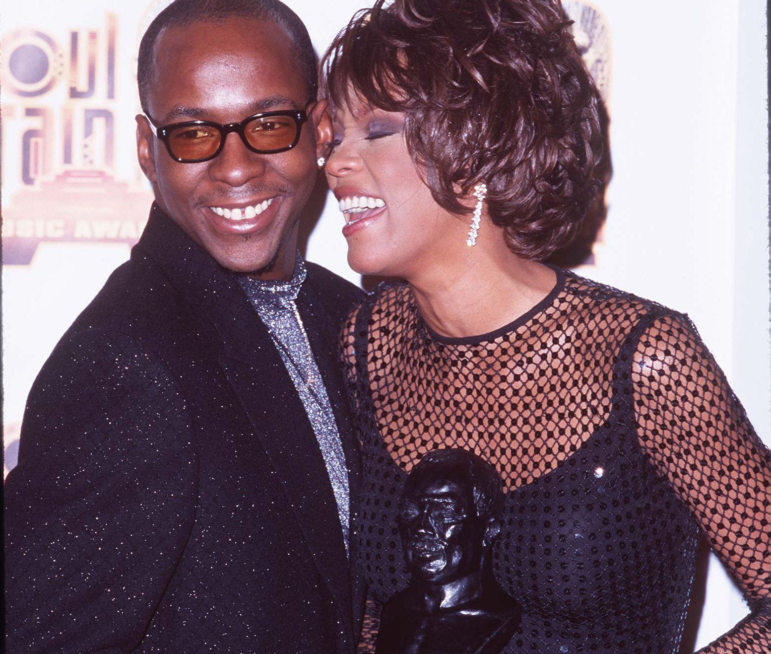 Bobby Brown and Whitney Houston smile at award show