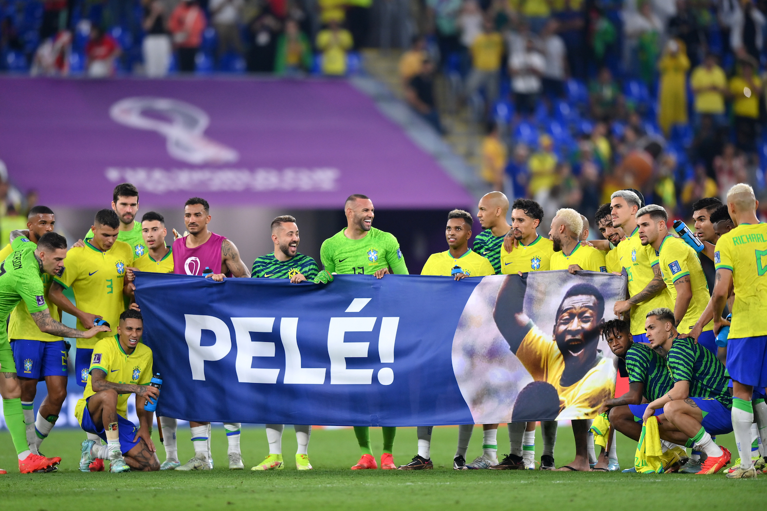 Brazil players hold a banner showing support for former Brazil player Pelé after the FIFA World Cup in 2022
