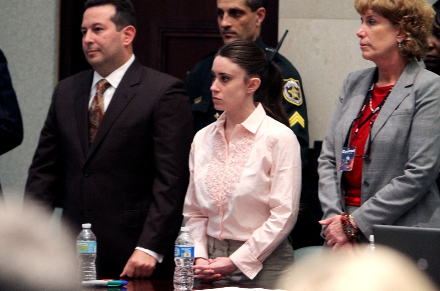 Casey Anthony, with her attorneys Jose Baez (L) and Dorothy Clay Sims (R) stand before the jury presents a verdict in her murder trial at the Orange County Courthouse on July 5, 2011 in Orlando, Florida. Casey Anthony had been accused of murdering her two-year-old daughter Caylee in 2008 and was found not guilty of manslaughter in the first degree on July 5 in Orlando, Florida.  