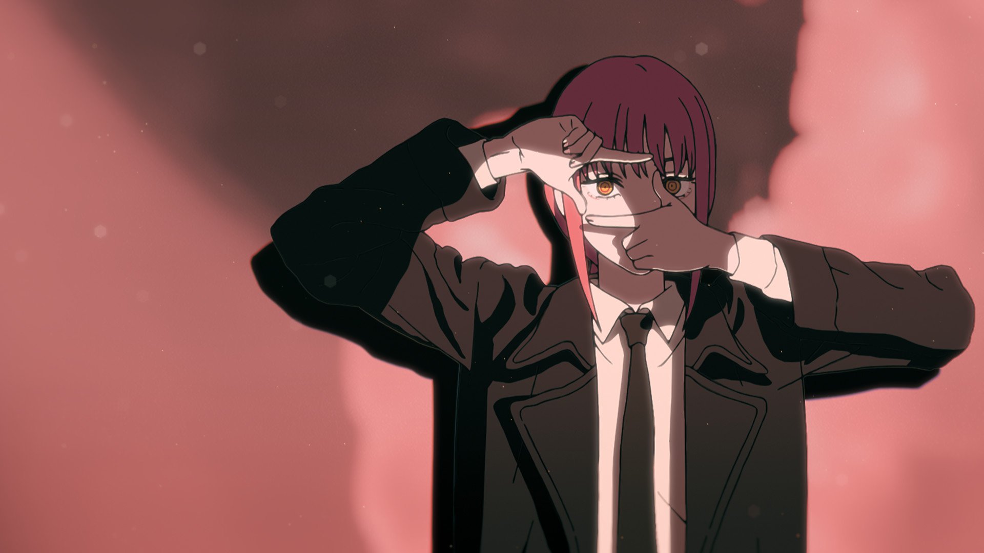 An image of Makima from 'Chainsaw Man's opening theme for our preview of episode 10. She's wearing a black suit and tie, and she's squaring her fingures and looking through them.
