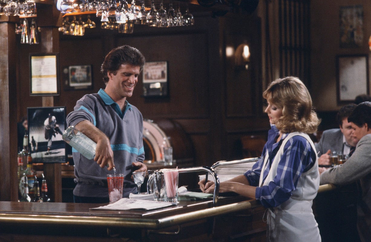 'Cheers': Sam (Ted Danson) pours a drink behind the bar while Diane (Shelley Long) waits
