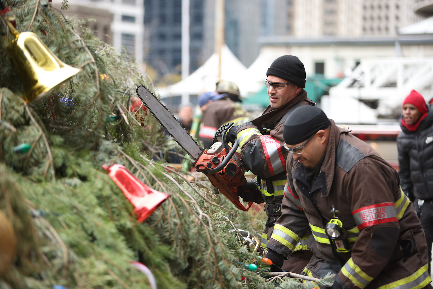 Kelly Severide and Joe Cruz cutting down a Christmas tree in 'Chicago Fire' Season 10