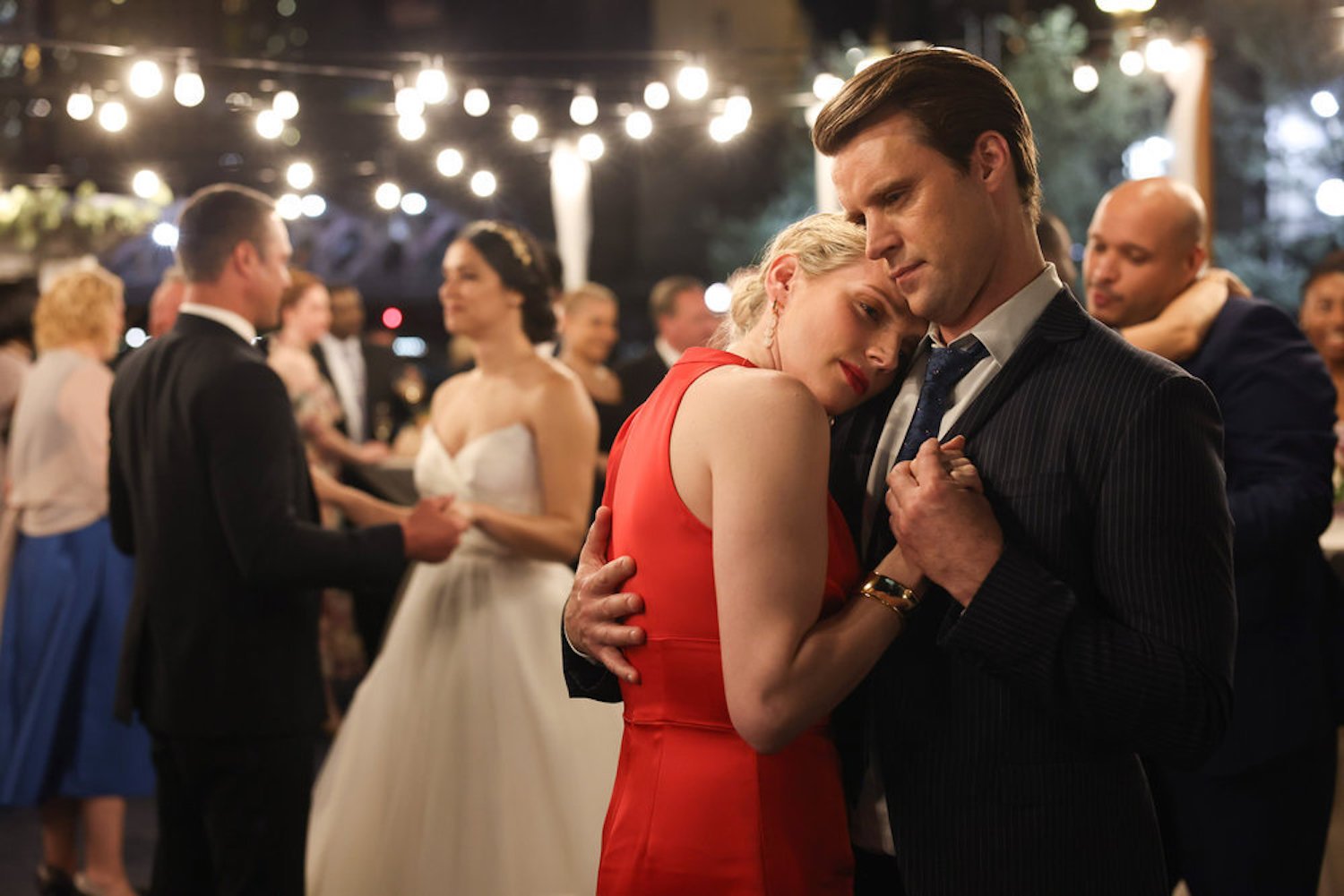 Kara Killmer as Sylvie Brett and Jesse Spencer as Matt Casey dancing at a wedding in 'Chicago Fire'