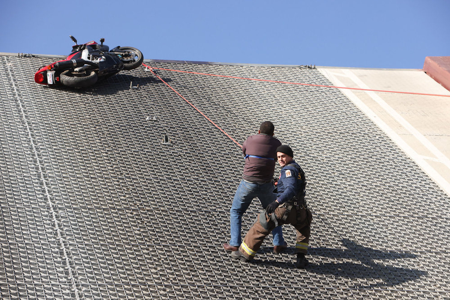 Firehouse 51 performing a rescue on the side of a building on 'Chicago Fire' Season 11 Episode 9