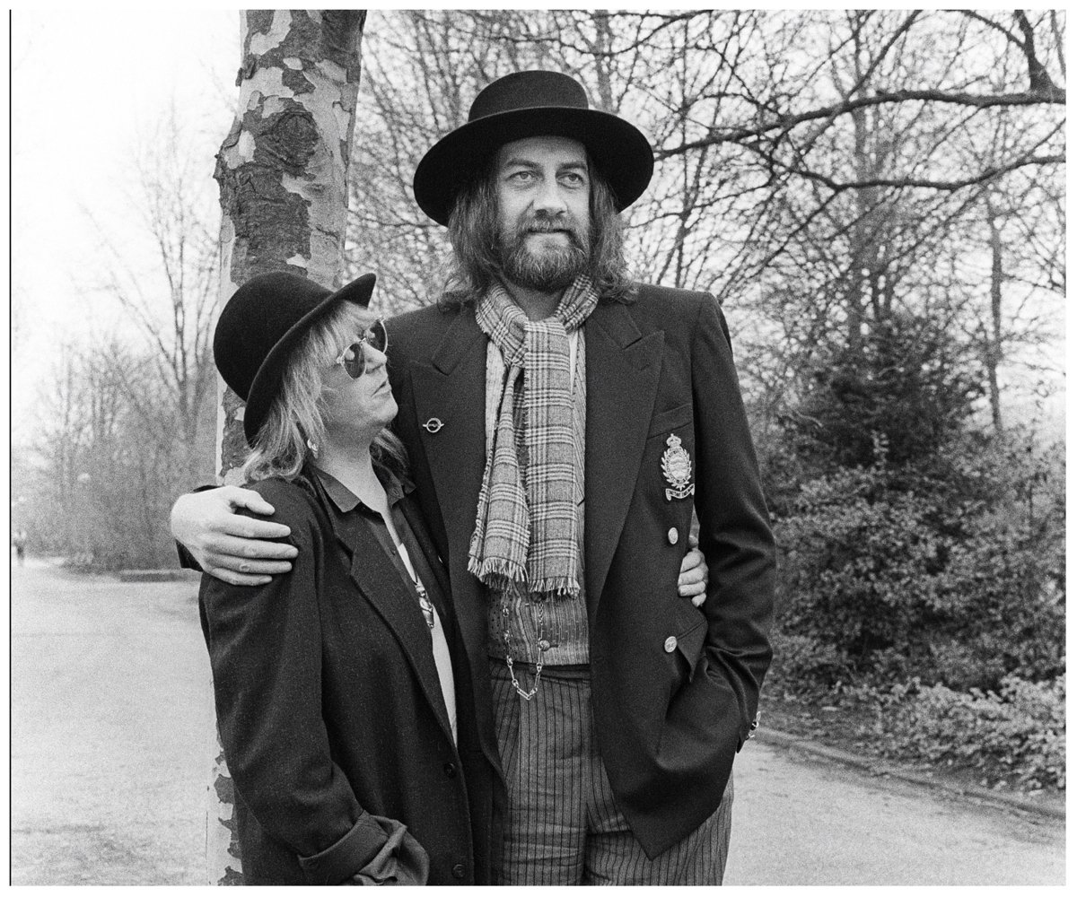 A black and white photo of Mick Fleetwood with his arm around Christine McVie, who wrote the song "Oh Daddy" for him.