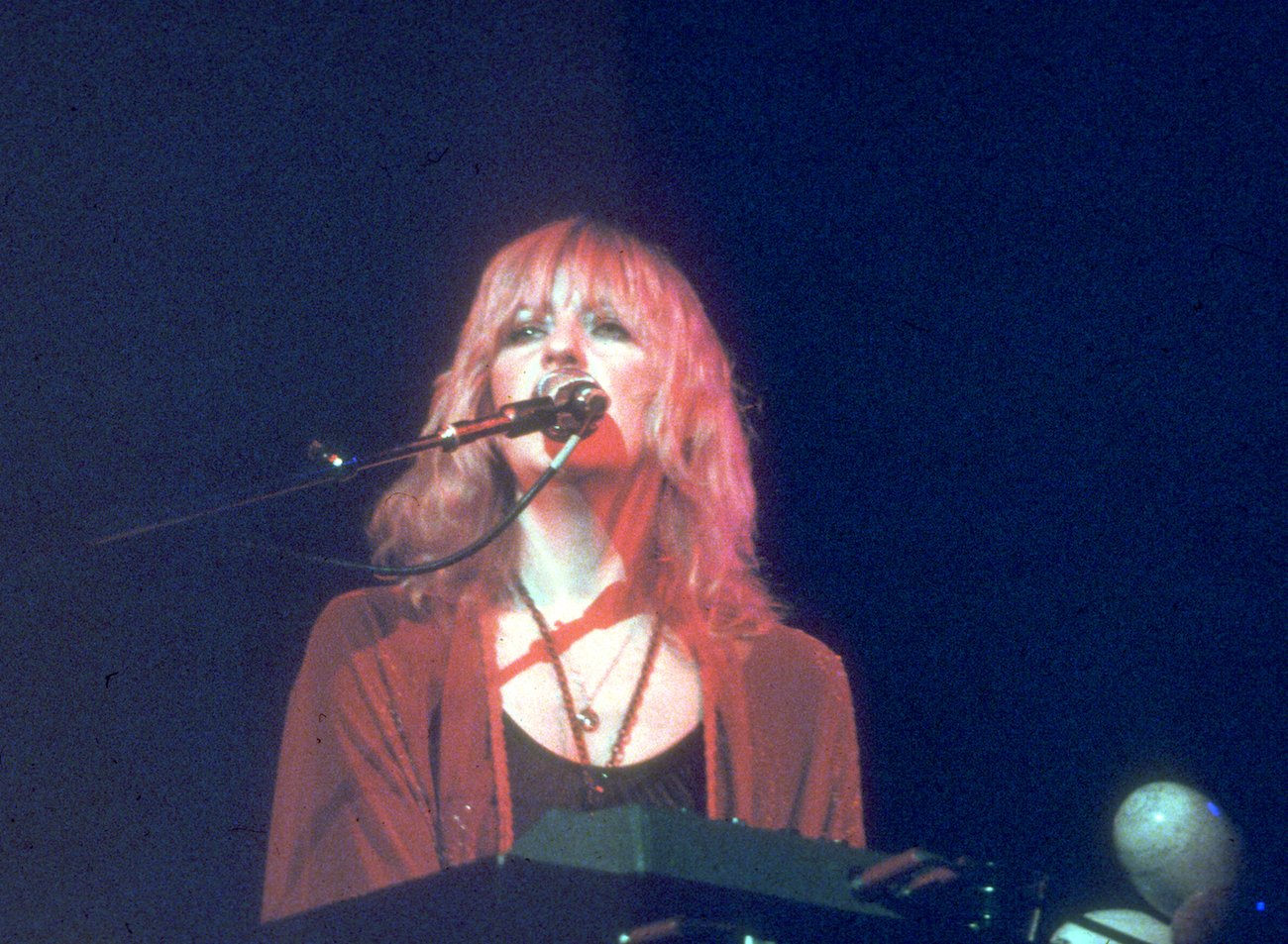 Christine McVie performing in red around 1970.