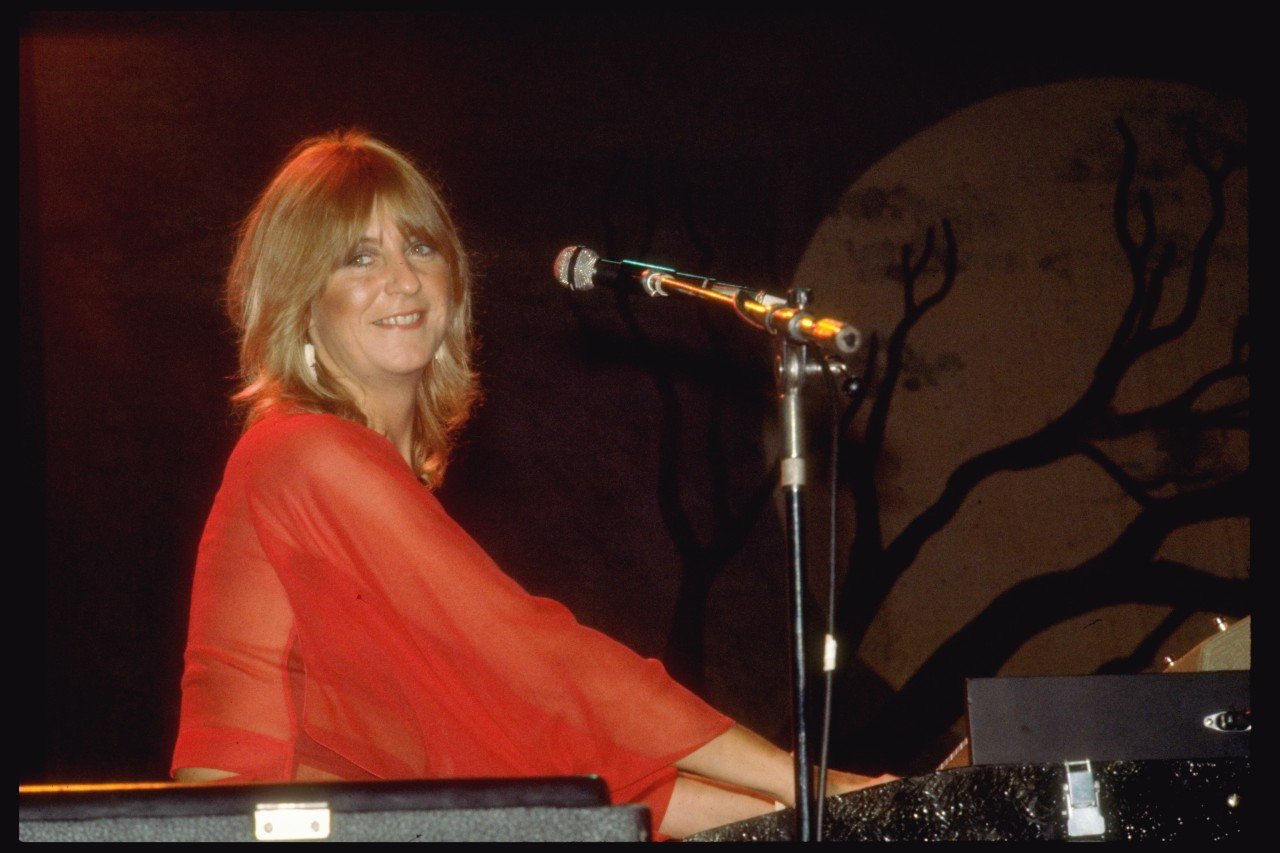 Christine McVie plays piano during a performance. 