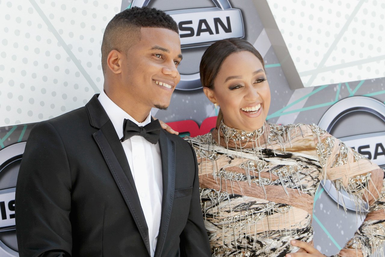 Cory Hardrict and Tia Mowry smile together on the red carpet